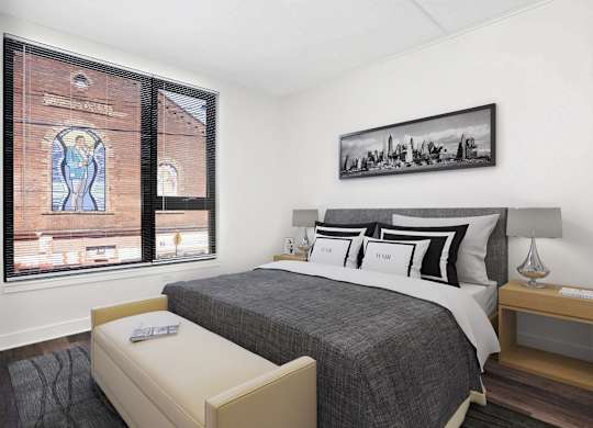 a bedroom with a bed and a large window