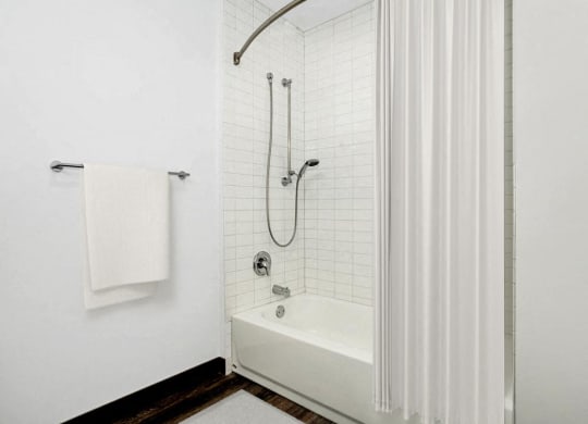 a white bathroom with a shower and a tub
