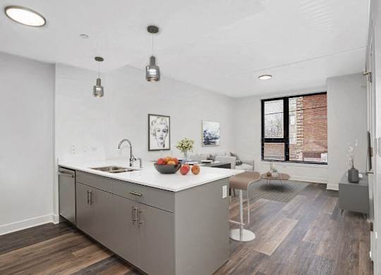 a kitchen with a large island and a living room