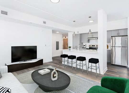 the living room and kitchen of a modern apartment