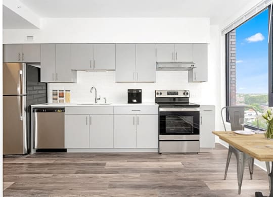 a modern kitchen with white cabinets and stainless steel appliances