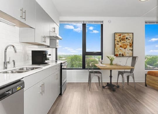 a kitchen with a table and a sink and a window