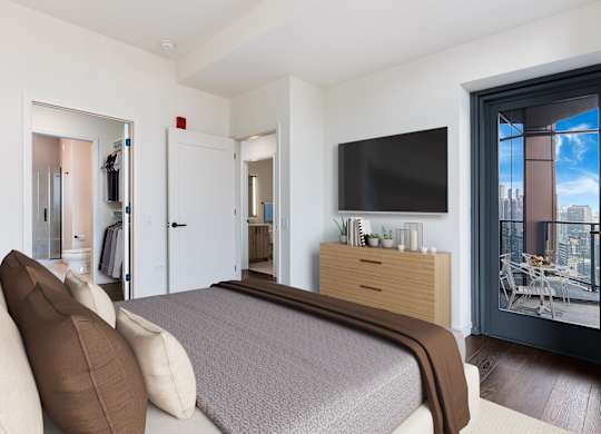 a bedroom with a large bed and a tv on the wall at Cassidy on Canal, Chicago, IL