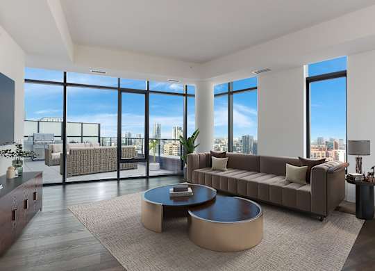 a living room with a couch and a coffee table in front of windows at Cassidy on Canal, Chicago, IL