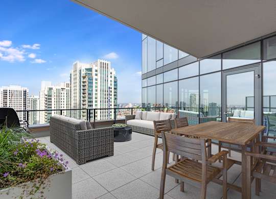a balcony with a table and chairs and a view of the city at Cassidy on Canal, Chicago, Illinois, 60606