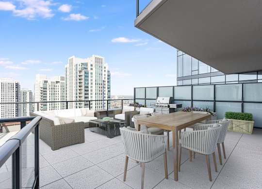 a rooftop terrace with a table and chairs and a view of the city at Cassidy on Canal, Chicago, Illinois, 60606