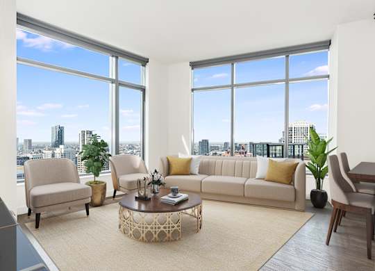 a living room with large windows and a couch and a coffee table at Cassidy on Canal, Chicago, 60606