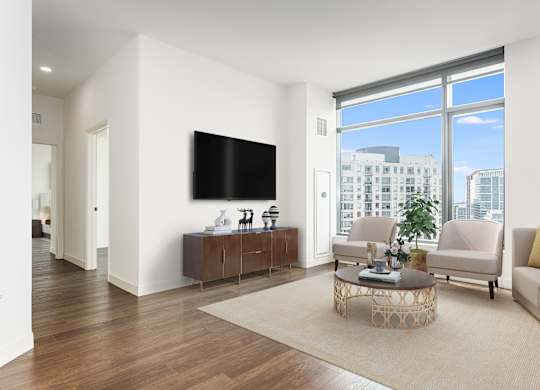 a living room with a large window and a television at Cassidy on Canal, Chicago, Illinois