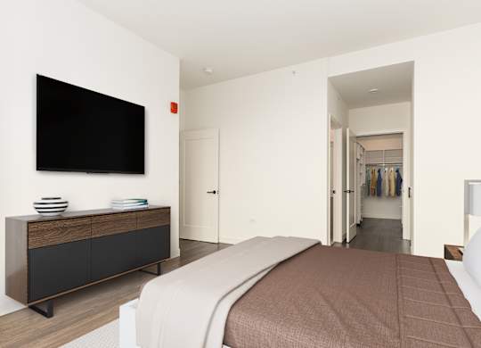 a bedroom with a bed and a tv on the wall at Cassidy on Canal, Chicago, Illinois, 60606