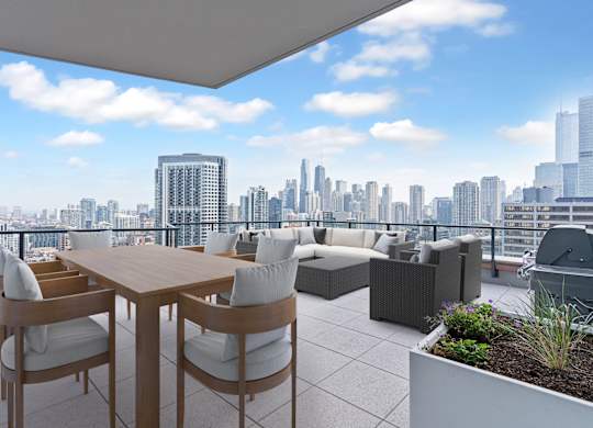 a terrace with a table and chairs and a view of the city at Cassidy on Canal, Chicago, 60606