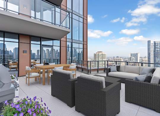 a rendering of a balcony with furniture and views of a city at Cassidy on Canal, Chicago, Illinois