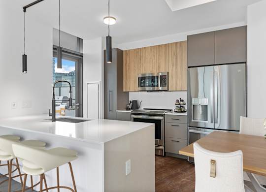 a kitchen with a large island and a table with chairs at Cassidy on Canal, Chicago, Illinois, 60606