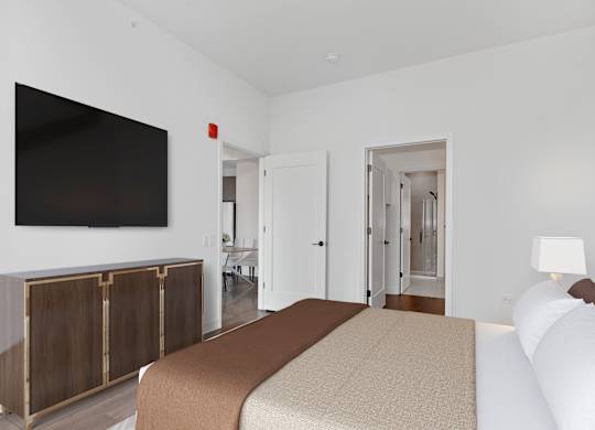 a bedroom with a bed and a tv on the wall at Cassidy on Canal, Chicago, IL