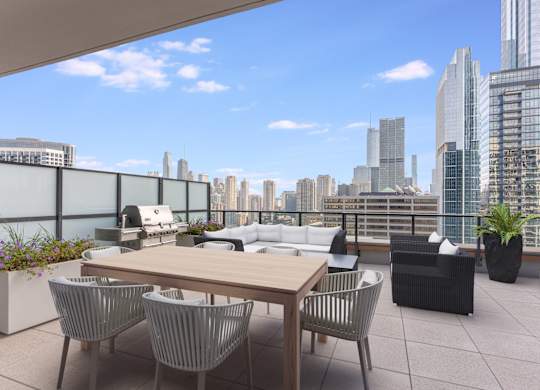 a terrace with a table and chairs overlooking a city at Cassidy on Canal, Chicago, 60606