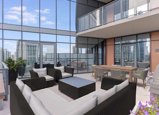 a living room with couches and a table in front of windows at Cassidy on Canal, Chicago, 60606
