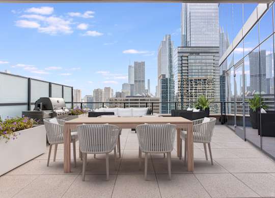 a communal terrace with a table and chairs and a view of the city at Cassidy on Canal, Chicago, Illinois, 60606