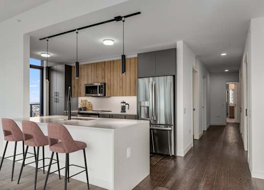 a kitchen with a large island with bar stools and a refrigerator at Cassidy on Canal, Illinois, 60606