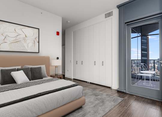 a bedroom with a bed and a sliding glass door to a balcony at Cassidy on Canal, Chicago, 60606