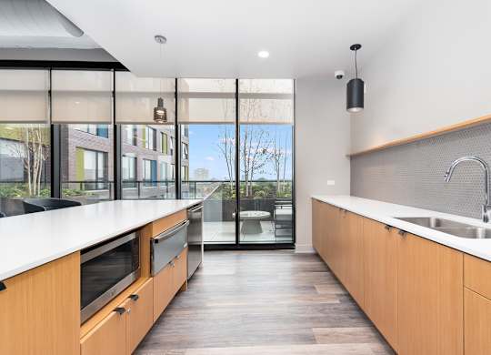 a kitchen with wooden cabinets and a sink and a large window