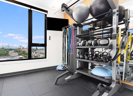 a gym with a view of the city and a large window