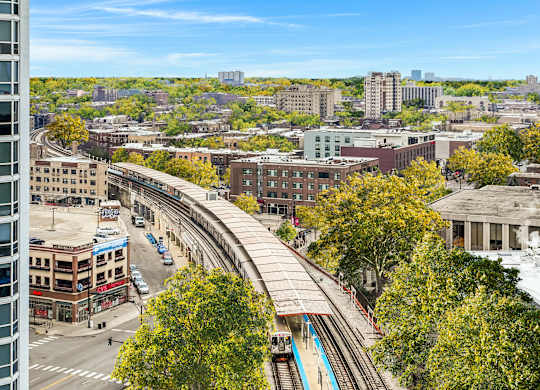 an aerial view of a city with train tracks