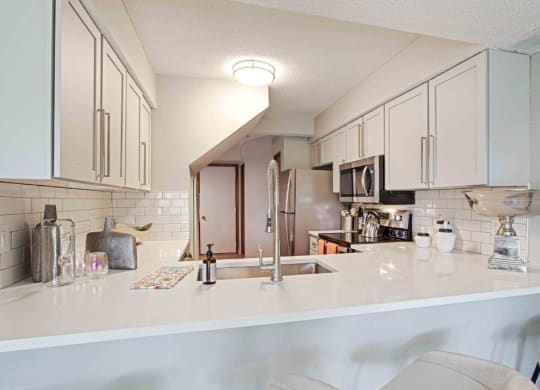 a kitchen with a counter top and a sink at Seasons Villas, Woodbury, MN 55125