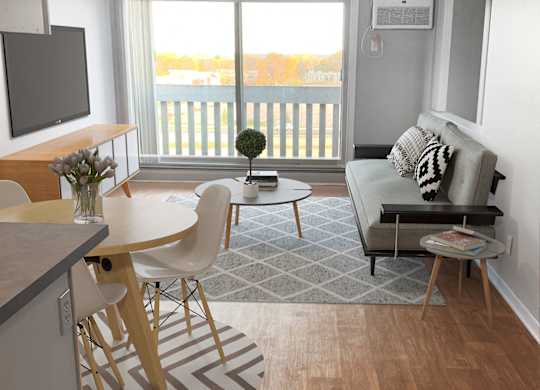 Open concept living dining area with modern furniture at Cedarvale Highlands Apartments, Eagan, MN
