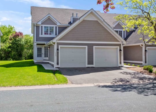 a house with a driveway and a garage door at Seasons Villas, Minnesota, 55125