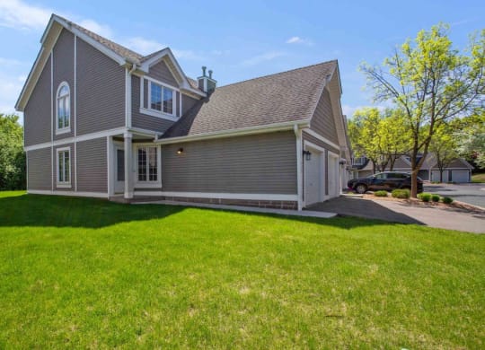 a gray house with a yard in front of it at Seasons Villas, Minnesota, 55125