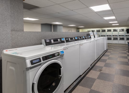a row of washing machines in a public laundromat at The Pavilion, Detroit, MI, 48207