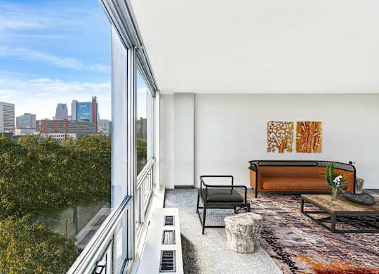 A modern living room with a view of the city skyline.
