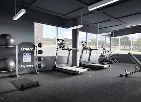 a workout room with weights and other exercise equipment and windows