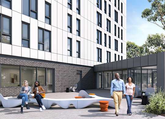 a group of people sitting on benches in front of a building