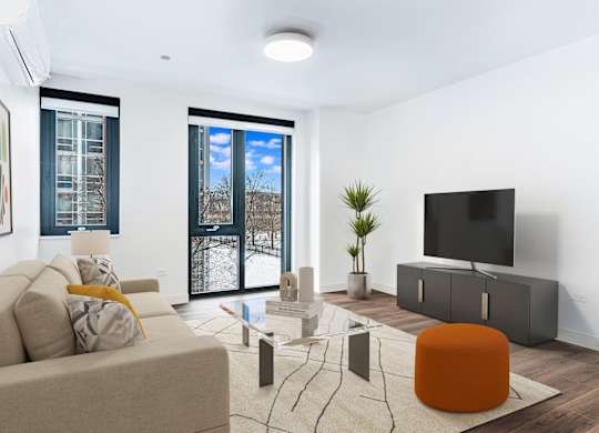 A modern living room with a large window and a flat screen TV.