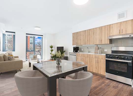 A modern kitchen with a glass table and chairs.