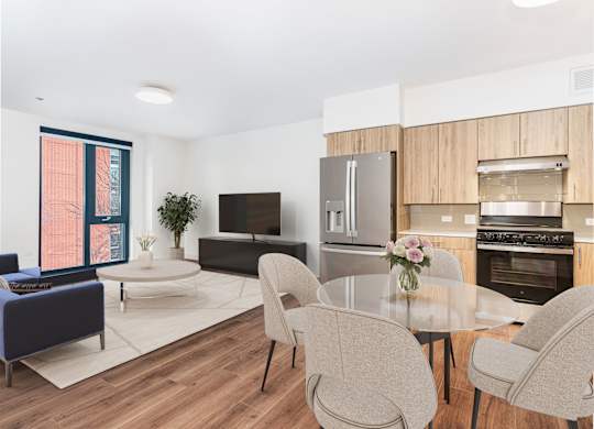 A modern kitchen with a dining table and chairs.