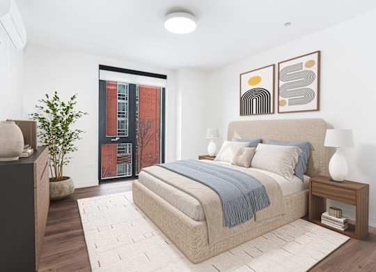A bedroom with a large bed and a potted plant.