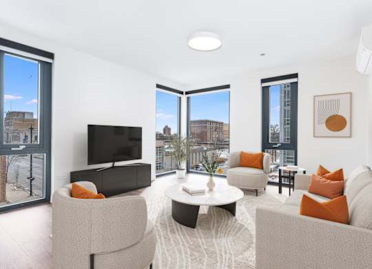 A living room with a television, two couches, and a coffee table.