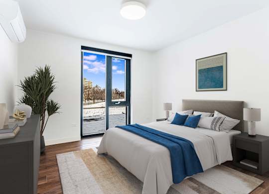 A bedroom with a large bed and a view of the outside.