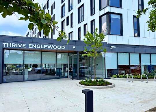 The Thrive Englewood building has a modern design with a glass facade.