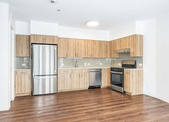 A modern kitchen with wooden cabinets and stainless steel appliances.