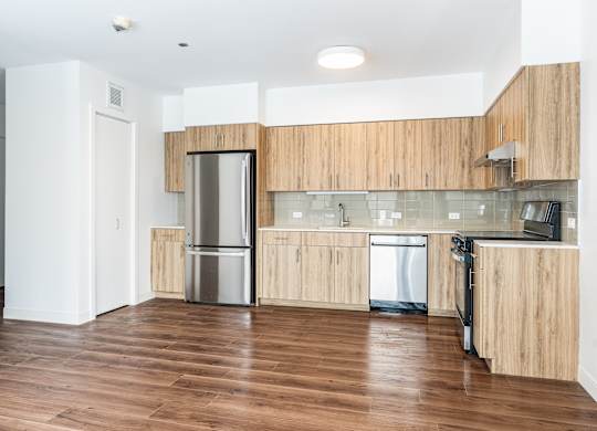 A kitchen with wooden cabinets and stainless steel appliances.