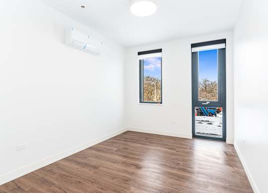 A room with a window and a door.