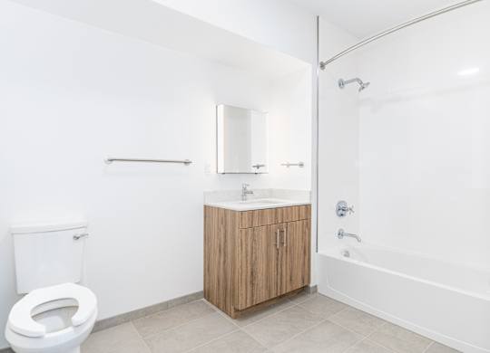 A white bathroom with a toilet, sink, and bathtub.