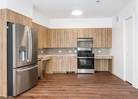 A modern kitchen with wooden cabinets and stainless steel appliances.