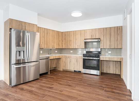 A modern kitchen with wooden cabinets and stainless steel appliances.