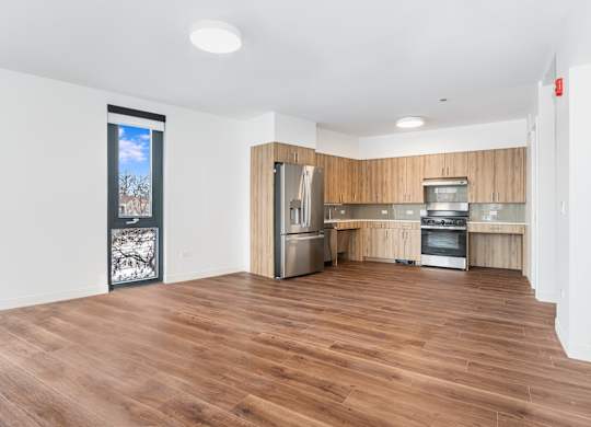 A kitchen with wooden floors and stainless steel appliances.