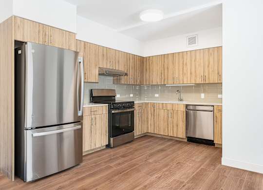 A kitchen with wooden cabinets and stainless steel appliances.