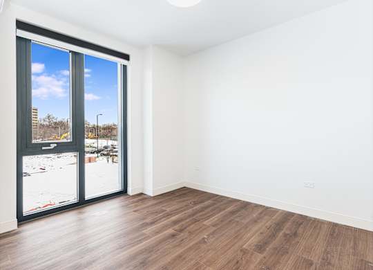 A room with a view of a snowy landscape outside.