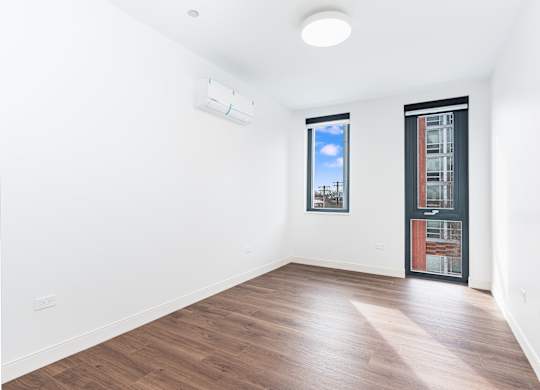 A room with a window and a door.